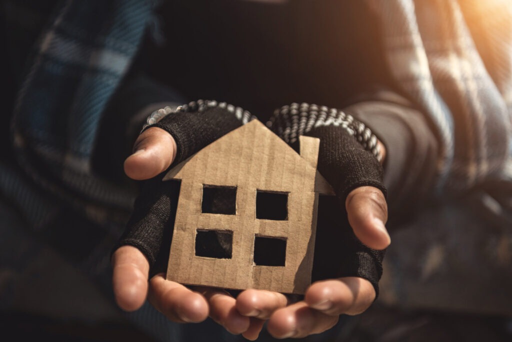 Hands Of Homelessness Poor Man Holding The Paper House Hope To H